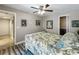Neutral bedroom featuring a decorative bed with floral bedding, ceiling fan, and wood-look flooring at 103 Red Cedar Dr, Longwood, FL 32779