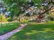 View of a park with beautiful old trees and a brick-paved walking path along a pond at 103 Red Cedar Dr, Longwood, FL 32779