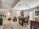 Dining room featuring a wooden table with comfortable chairs, backyard access, and neutral walls at 103 Red Cedar Dr, Longwood, FL 32779