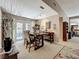 Open dining area with modern track lighting, patio access and views to the adjoining living area at 103 Red Cedar Dr, Longwood, FL 32779