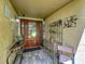 Covered front entrance with tiled floor, decorative furniture, and glass accented door at 103 Red Cedar Dr, Longwood, FL 32779