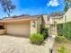 Townhome with a two-car garage and charming walkway to gated front entrance at 103 Red Cedar Dr, Longwood, FL 32779