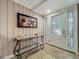 Foyer featuring paneled walls, tile flooring, and decorative front door at 103 Red Cedar Dr, Longwood, FL 32779