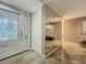 Bright foyer featuring tile floors, a mirrored wall, and a decorative glass accented door at 103 Red Cedar Dr, Longwood, FL 32779