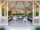 Charming gazebo featuring a ceiling fan, seating, and views of the lush garden at 103 Red Cedar Dr, Longwood, FL 32779