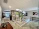 Bright hallway featuring stone accent wall, skylight, mirrored wall, and view of Gathering room at 103 Red Cedar Dr, Longwood, FL 32779