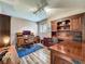 Spacious home office with hardwood floors, built-in shelving, and a large wooden desk at 103 Red Cedar Dr, Longwood, FL 32779