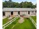 Exterior view of the horse barn with white fence and green pasture; a picturesque country setting at 103 Red Cedar Dr, Longwood, FL 32779