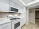 Clean white kitchen featuring stainless steel appliances and bright countertops with neutral flooring at 103 Red Cedar Dr, Longwood, FL 32779