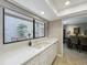Kitchen sink beneath a picture window with stone wall views in an all white galley style design at 103 Red Cedar Dr, Longwood, FL 32779