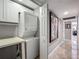 Efficient laundry room featuring a stackable washer and dryer and overhead cabinets at 103 Red Cedar Dr, Longwood, FL 32779