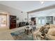Open-concept living area featuring neutral walls, plush furniture, and french doors to the exterior at 103 Red Cedar Dr, Longwood, FL 32779