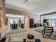 Spacious open-concept living area with stone fireplace, dining area and access to exterior at 103 Red Cedar Dr, Longwood, FL 32779