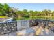 Pond featuring stone border, calm water, and landscaped surroundings with lush green trees and plants at 103 Red Cedar Dr, Longwood, FL 32779
