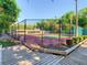 Fenced tennis court with a walkway leading to the court at 103 Red Cedar Dr, Longwood, FL 32779