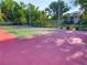 Outdoor tennis court surrounded by mature trees and landscaping at 103 Red Cedar Dr, Longwood, FL 32779