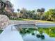 Beautiful water feature with stone wall and tropical plants reflecting in the water at 103 Red Cedar Dr, Longwood, FL 32779