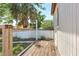 Back deck with wooden floors and a metal wire fence surrounding the perimeter of the backyard area at 1032 Perkins Rd, Orlando, FL 32809