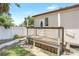 Back porch with weathered wooden planks and a wire fence, leading to the front door at 1032 Perkins Rd, Orlando, FL 32809
