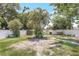 Fenced backyard with a palm tree, and grassy areas at 1032 Perkins Rd, Orlando, FL 32809