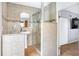 Bathroom with a glass shower, a beige tile surround, and a pedestal sink at 1032 Perkins Rd, Orlando, FL 32809