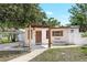 Charming home with a pergola covered front porch and well-maintained lawn at 1032 Perkins Rd, Orlando, FL 32809