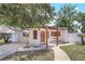 Charming single-story home showcasing a covered front porch and a manicured walkway at 1032 Perkins Rd, Orlando, FL 32809
