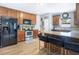 Kitchen features wood cabinets, stainless steel appliances, granite countertops and island with bar stool seating at 1032 Perkins Rd, Orlando, FL 32809
