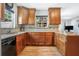 Updated kitchen featuring wood cabinets, tile backsplash, granite countertops and stainless steel appliances at 1032 Perkins Rd, Orlando, FL 32809