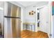 Kitchen space showcasing hardwood floors, stainless steel fridge, and an open doorway at 1032 Perkins Rd, Orlando, FL 32809