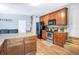 Kitchen with wood cabinets, stainless steel appliances, granite countertops and a breakfast bar at 1032 Perkins Rd, Orlando, FL 32809