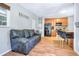 Living room featuring tile floors adjacent to kitchen with breakfast bar at 1032 Perkins Rd, Orlando, FL 32809