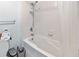 Bathroom area featuring a shower and tub combination, with a white shower curtain and tile at 1038 Waterside Dr, Celebration, FL 34747