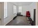 Bright room with exercise equipment, natural light from two windows, carpet, and red chair at 1038 Waterside Dr, Celebration, FL 34747
