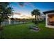 Backyard with a stunning sunset view over the lake, enhanced by a fountain and inviting outdoor lounge area at 10529 Royal Cypress Way, Orlando, FL 32836