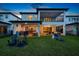 Backyard with patio, outdoor kitchen, covered seating, pool, and lake views, perfect for outdoor relaxation at 10529 Royal Cypress Way, Orlando, FL 32836