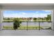 Balcony overlooking a serene lake with fountain and lush landscaping at 10529 Royal Cypress Way, Orlando, FL 32836