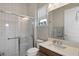 Bathroom featuring a glass shower, white tiles, and a white countertop sink at 10529 Royal Cypress Way, Orlando, FL 32836