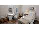 Well-lit bedroom with a desk, chair, bed, and bench on hardwood floors at 10529 Royal Cypress Way, Orlando, FL 32836