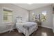 Bright bedroom with white furnishings, a decorative painting, and two windows at 10529 Royal Cypress Way, Orlando, FL 32836