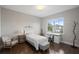 Bright bedroom with a desk, bed, and chair with hardwood floors and natural light at 10529 Royal Cypress Way, Orlando, FL 32836