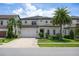 Beautiful two story home featuring a brick driveway, meticulous landscaping, and a two car garage at 10529 Royal Cypress Way, Orlando, FL 32836