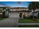 Beautiful two story home featuring a brick driveway, meticulous landscaping, and a two car garage at 10529 Royal Cypress Way, Orlando, FL 32836
