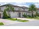 Elegant two-story home with a three-car garage, manicured landscaping, and a welcoming brick driveway at 10529 Royal Cypress Way, Orlando, FL 32836