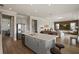 Open kitchen with gray cabinets, center island with bar seating, and stainless steel appliances at 10529 Royal Cypress Way, Orlando, FL 32836