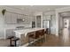 Bright kitchen featuring gray cabinets, stainless steel appliances, center island, and hardwood floors at 10529 Royal Cypress Way, Orlando, FL 32836