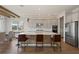 Open kitchen with gray cabinets, center island, stainless steel appliances, and hardwood floors at 10529 Royal Cypress Way, Orlando, FL 32836