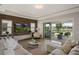 Bright living room featuring hardwood floors, recessed lights, a modern decor, and a patio view at 10529 Royal Cypress Way, Orlando, FL 32836