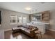 Stylish living room with a wet bar, a comfortable brown couch, and hardwood floors at 10529 Royal Cypress Way, Orlando, FL 32836