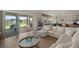 Open floor plan showcasing the living room, kitchen, and dining area with water views through sliding glass doors at 10529 Royal Cypress Way, Orlando, FL 32836